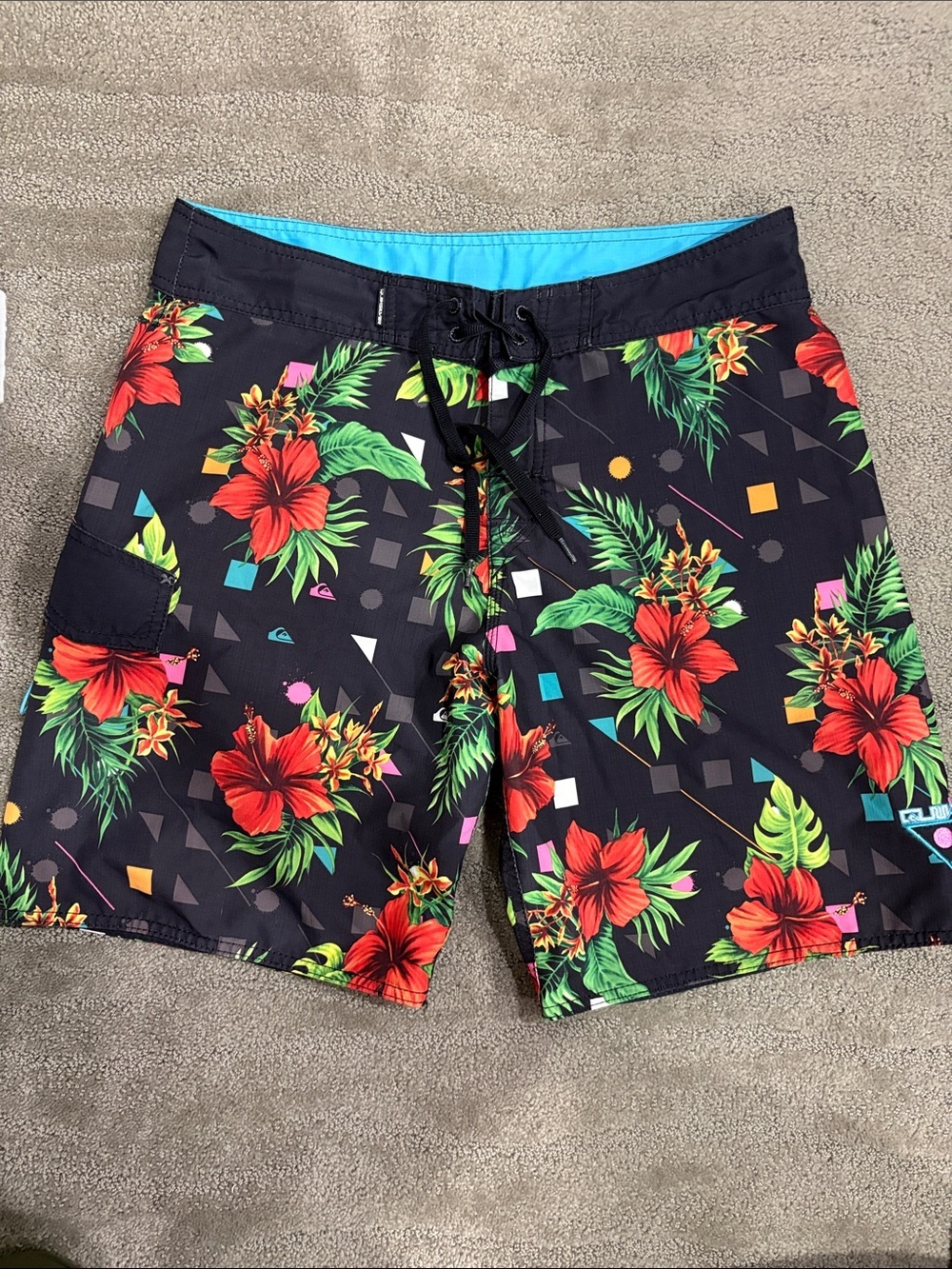 Quiksilver Black Board Shorts with Red Hibiscus and Green Foliage